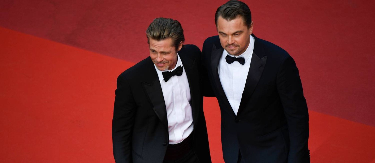 Brad Pitt e Leonardo DiCaprio no tapete vermelho de Cannes, onde "Era uma vez em Hollywood" concorre à Palma de Ouro Foto: CHRISTOPHE SIMON / AFP