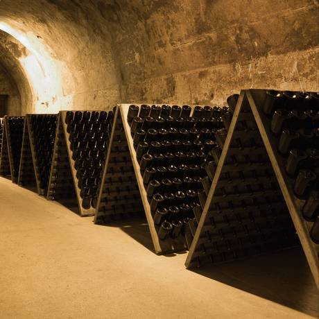 Garrafas de champanhe em cave da Taittinger em Reims, na região de Champagne-Ardenne, na França. Foto: Tim Graham / Getty Images