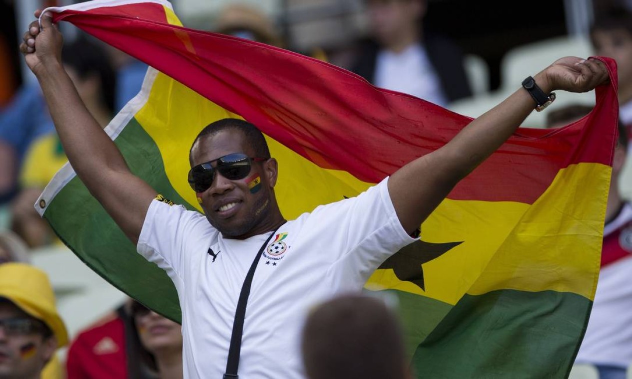 O ganense exibe a bandeira, orgulhoso. Seleção de Gana encara a da Alemanha Foto: Guito Moreto / Agência O Globo