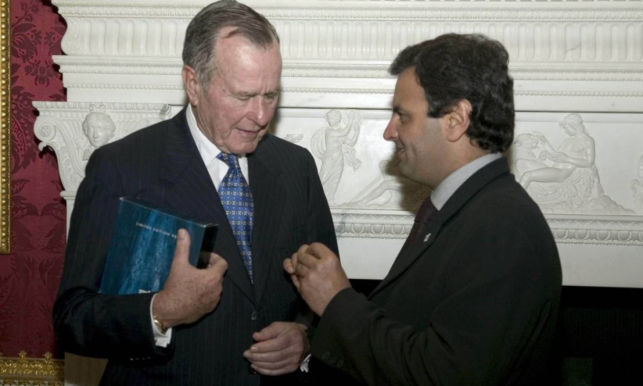 Em 2004, Aécio Neves entrega a George Bush broche de lapela com a bandeira de Minas Gerais no Fórum das Américas Foto: Eduardo Martino / Divulgação