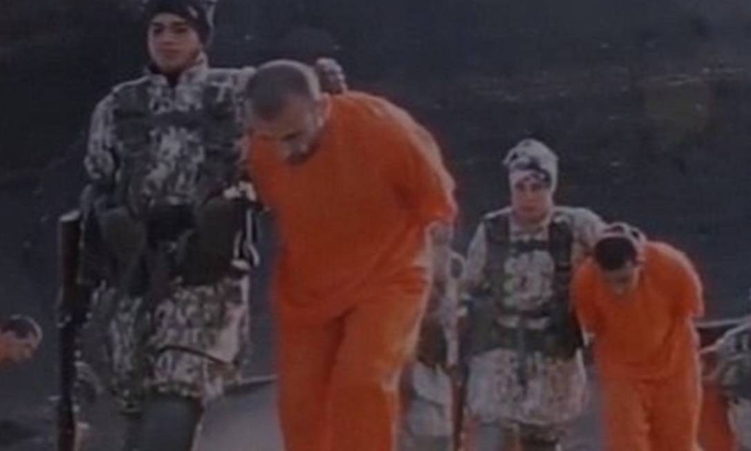 Заключенные согнуты, когда их забирают в ту часть пустыни, где их казнят Фото: Репродукция / Видео 