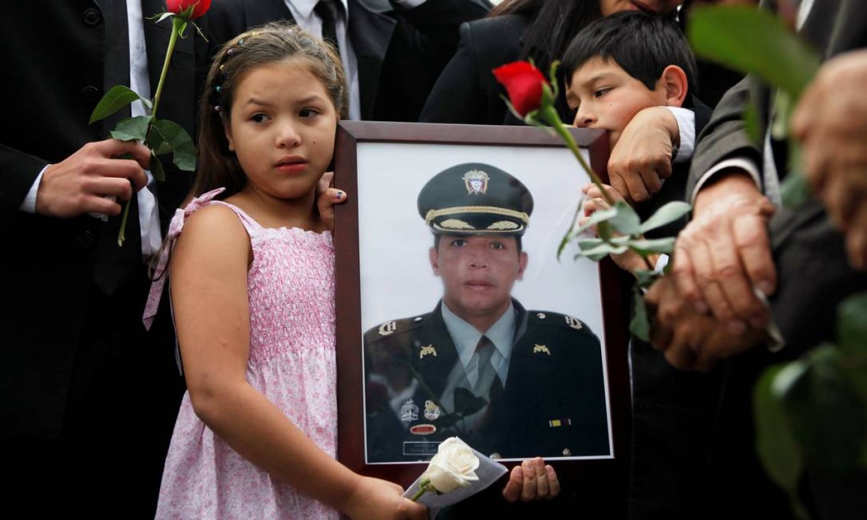 Natalia, filha do coronel da polícia Cristian Flores, morto em combate com as Farc em 2012, exibe seu retrato: guerrilha se enfraqueceu nos últimos anos Foto: John Vizcaino / REUTERS