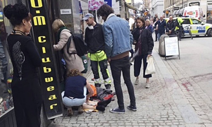 66198632_An-injured-person-on-the-ground-centreis-helped-near-scene-after-a-truck-crashed-into.jpg