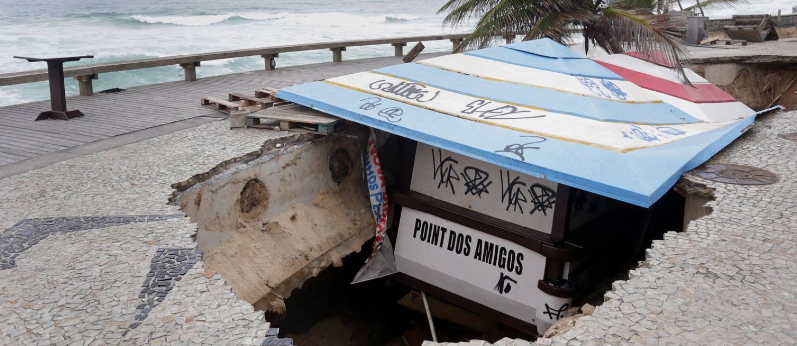 Quiosque que afundou na Praia da Macumba está preso pelo teto Foto: Márcio Alves / Agência O Globo