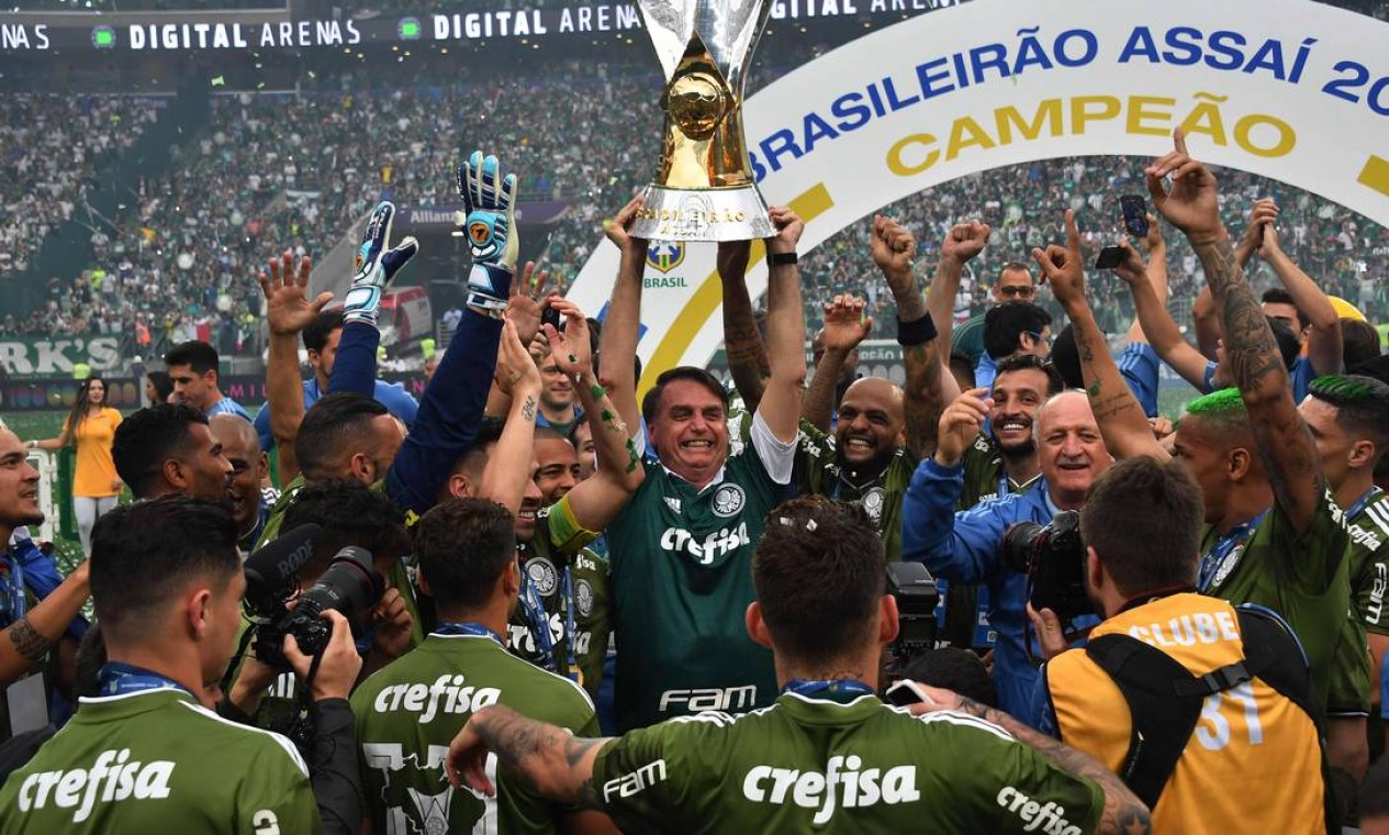 Recém eleito presidente, Bolsonaro se junta aos jogadores e levanta taça de campeão do Palmeiras Foto: NELSON ALMEIDA / AFP