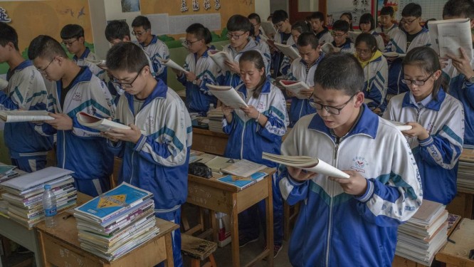 Estudantes leem livros didÃ¡ticos para memorizÃ¡-los, em escola de Huining, na China Foto: GILLES SABRIÃ / NYT