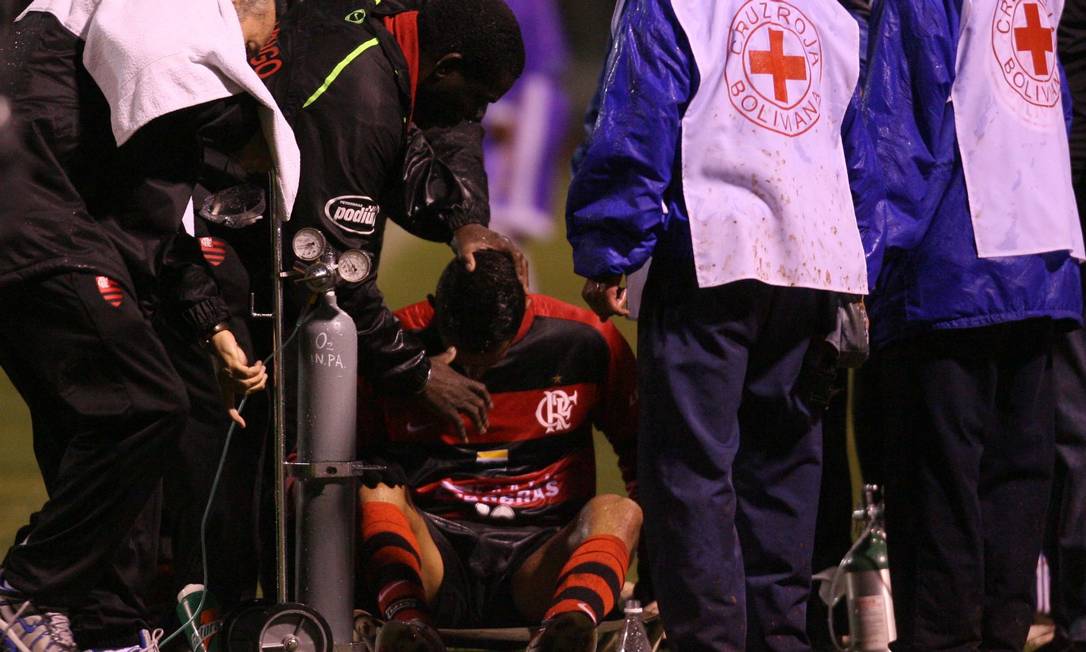 Renato Augusto é atendido pelo médico Serafim Borges : exausto, o meia-atacante do Flamengo teve de usar o balão de oxigênio Foto: Alexandre Cassiano