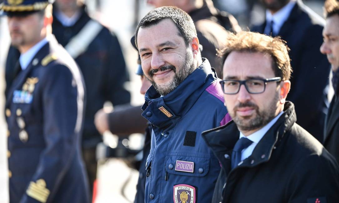O ministro do Interior e vice-premiê da Itália, Matteo Salvini (à esquerda), e o ministro da Justiça, Alfonso Bonafede (à direita), acompanham a chegada do ex-guerrilheiro Cesare Battisti à Itália no aeroporto Ciampino ALBERTO PIZZOLI / AFP