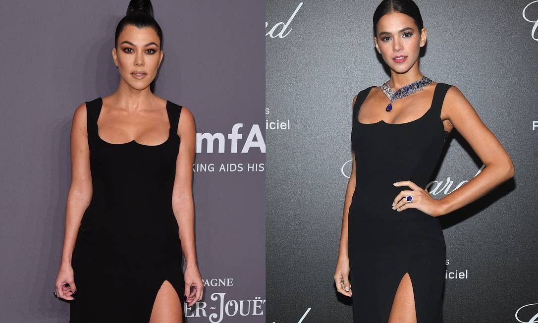 Kourtney Kardashian parou o tapete vermelho do baile beneficente da amfAR, em Nova Yoek, nesta quarta-feira, com um vestidinho preto Versace. Uma olhada mais atenta, revela que o look é um velho conhecido da turma da moda e dos brasileiros. No ano passado, Bruna Marquezine usou a peça em Cannes Foto: ANGELA WEISS / AFP e Getty Images