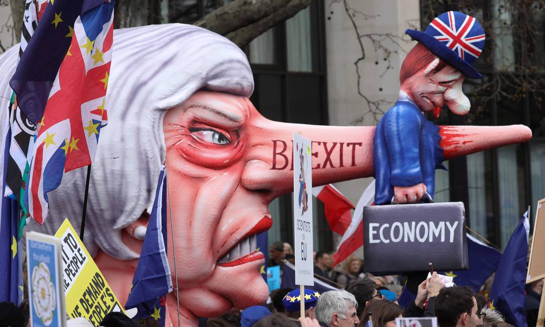 Um boneco que representa a primeira-ministra Theresa May é levado pelos manifestantes pelas ruas de Londres. Eles pedem um segundo referendo sobre o Brexit Foto: ISABEL INFANTES / AFP
