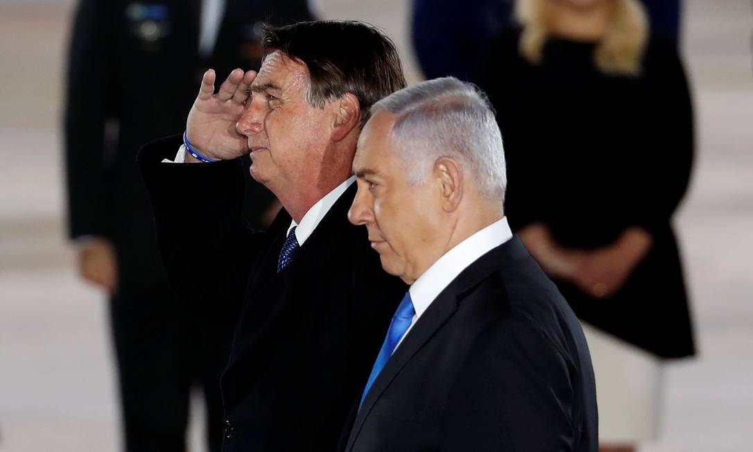 Presidente Jair Bolsonaro bate continência ao ser recebido em Israel pelo premier Benjamin Netanyahu Foto: RONEN ZVULUN / REUTERS