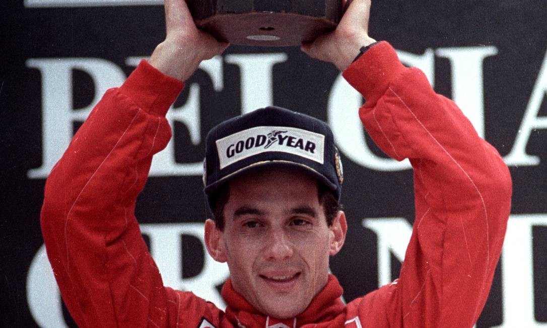 FILE PHOTO: Ayrton Senna of Brazil raises his trophy after winning the Belgian Grand Prix August 28, 1988. SCANNED FROM NEGATIVE. REUTERS/Frederique Lengaigne/File Photo PLEASE SEARCH 