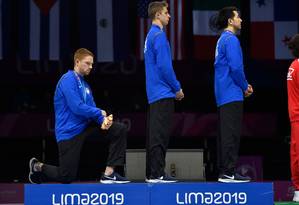 US' Race Imboden(L) kneels next to Nick Itkin(C), and Gerek Meinhardt during the national anthem at the Men's Foil Team medal ceremony in Fencing, at the Lima Convention Center during the Pan American Games Lima 2019 in Lima on August 09, 2019. (Photo by Jose Sotomayor - Lima 2019 / Lima 2019 / AFP) Foto: JOSE SOTOMAYOR - LIMA 2019 / AFP