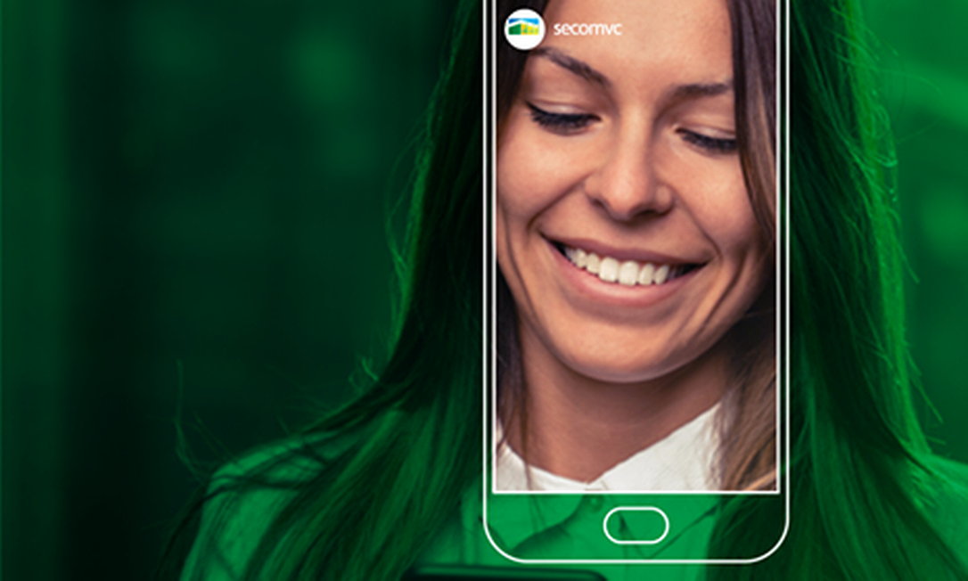 Identidade visual do 'SecomVC' inclui mulher sorrindo ao olhar um aparelho celular Foto: Divulgação