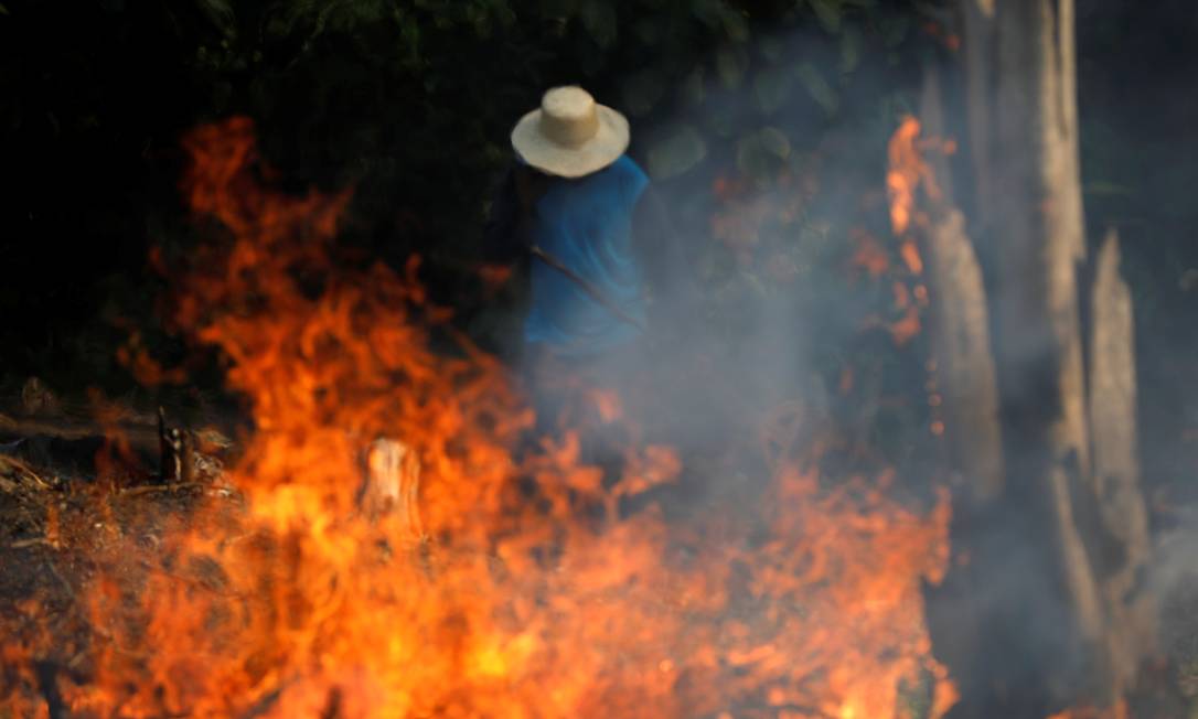Homem trabalha em área com queimada no Amazonas Foto: Bruno Kelly / Reuters