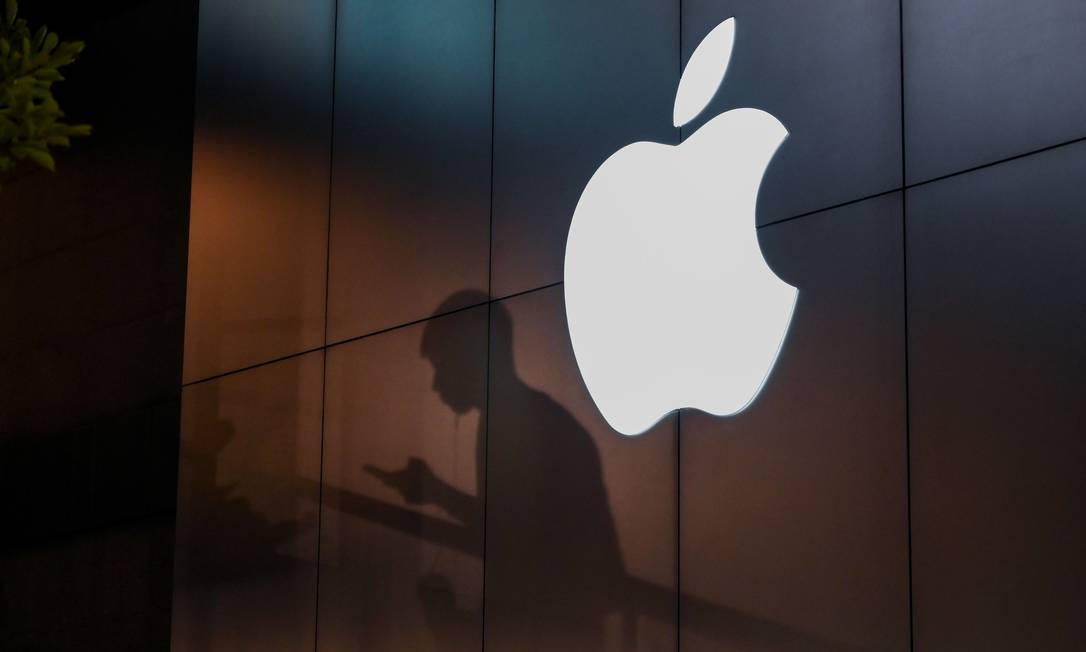 The shadow of a man is cast on the wall of an Apple store as he uses his mobile phone in Beijing on August 26, 2019. - There were signs of a thaw in frosty trade-war tensions between China and the US on August 26 as President Donald Trump said delegations would "very shortly" resume talks and Beijing's top negotiator called for "calm". (Photo by GREG BAKER / AFP) Foto: GREG BAKER / AFP