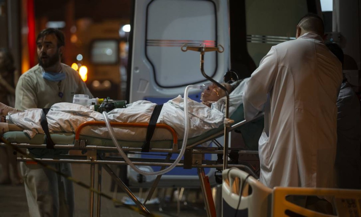 Pacientes que não podiam se locomover sozinhos foram retirados do hospital de maca Foto: Alexandre Cassiano / Agência O Globo