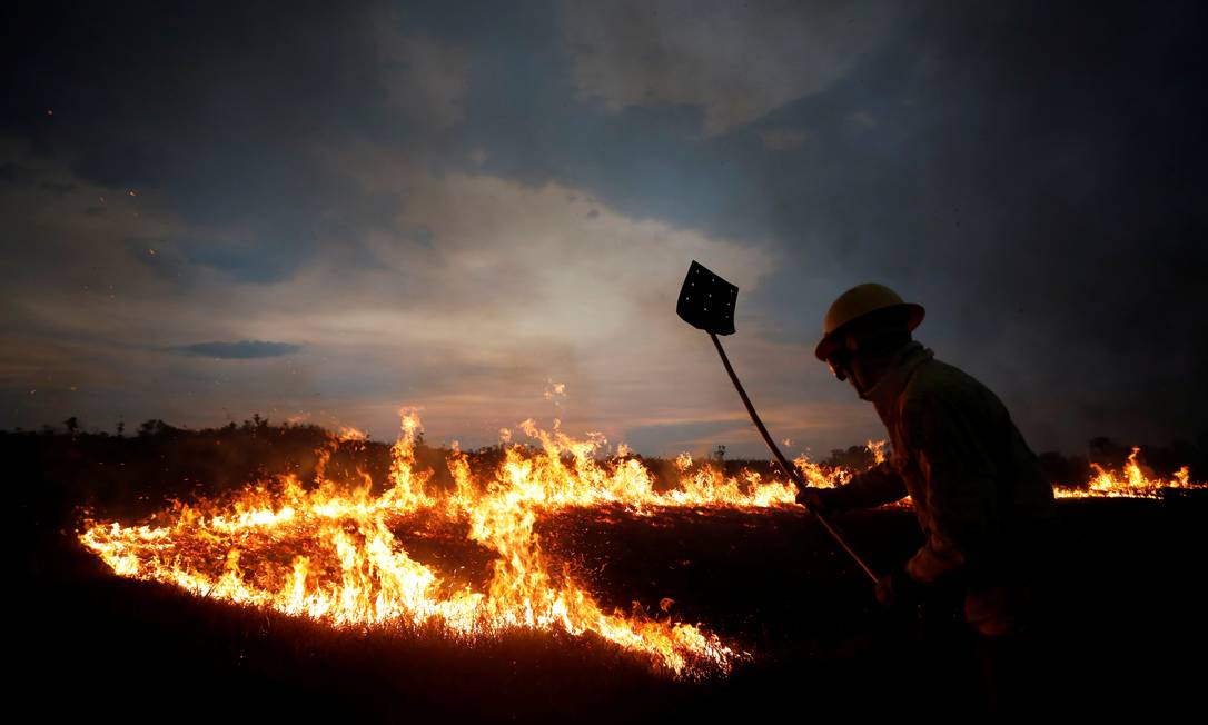 Agente da brigada anti-incêndio do Ibama tenta conter chamas na terra indígena Tenharim Marmelos, no Amazonas Foto: BRUNO KELLY / REUTERS
