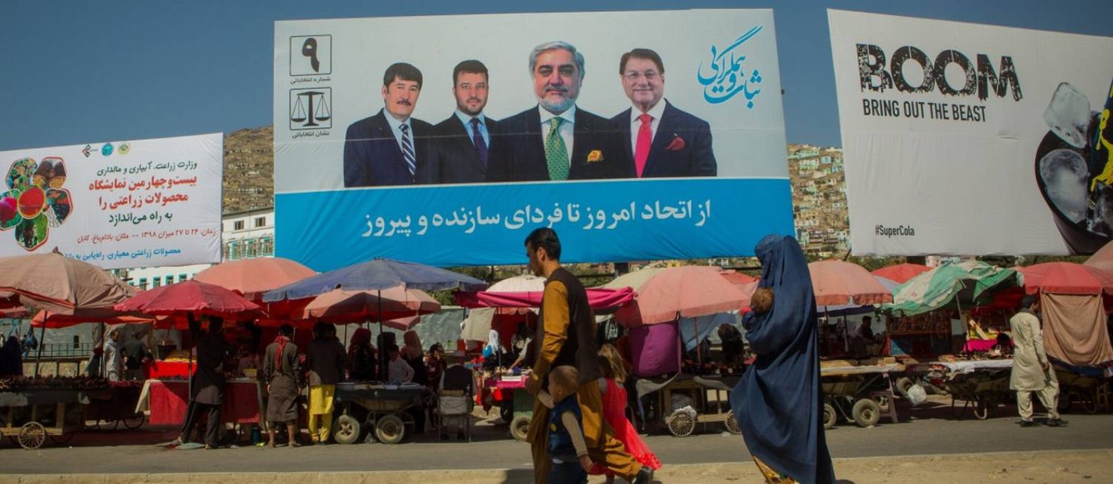 Kabul (Afghanistan) -19/09/2019) - An Afghan family walks by an election propaganda of Abdullah Abdullah, the main adversary of the Afghan President Ashraf Ghani in the upcoming elections