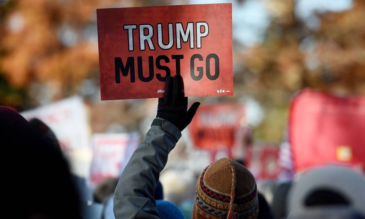 "Trump deve sair", diz o cartaz de manifestante, em frente ao Capitólio, em Washington, nesta quarta-feira Foto: Olivier Douliery / AFP