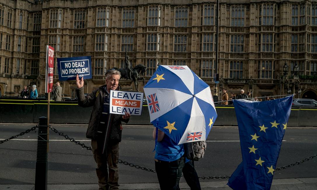Manifestantes contra e a favor do Brexit vistos do lado de fora do Parlamento, em Londres Foto: ANDREW TESTA / NYT/04-01-2020