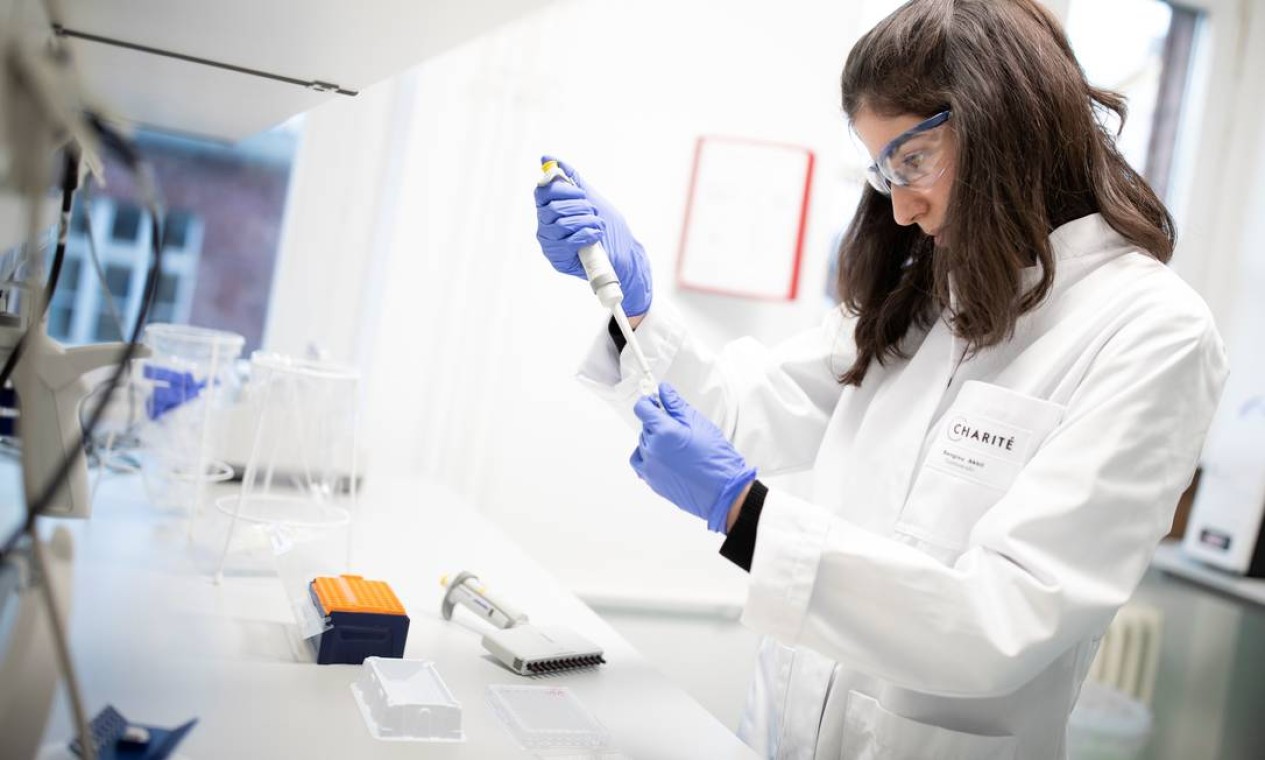Funcionária do departamento de virologia do hospital Charite prepara um teste para o novo coronavírus, em Berlim, na Alemanha. A Organização Mundial da Saúde convocou uma reunião para quarta-feira para avaliar a declaração de uma emergência internacional de saúde Foto: AXEL SCHMIDT / REUTERS