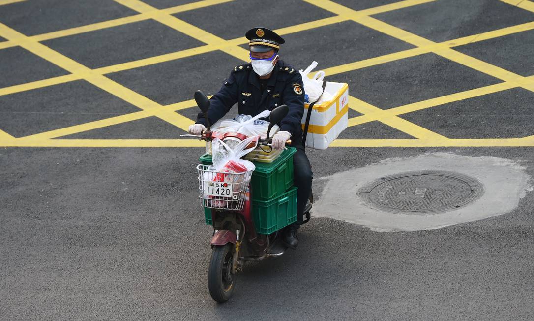 Homem com estoque de comida em Wuhan Foto: STRINGER/REUTERS / STRINGER/REUTERS