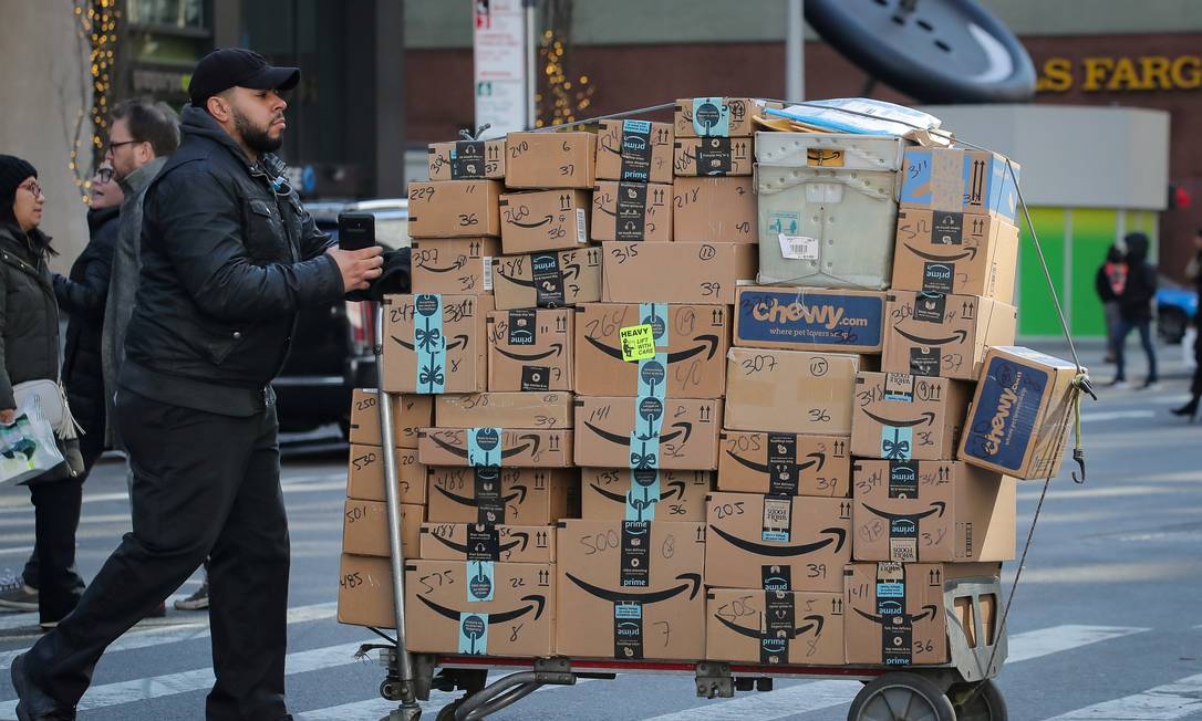 Entregador empurra um carrinho cheio de caixas da Amazon em Nova York Foto: Brendan McDermid / Reuters