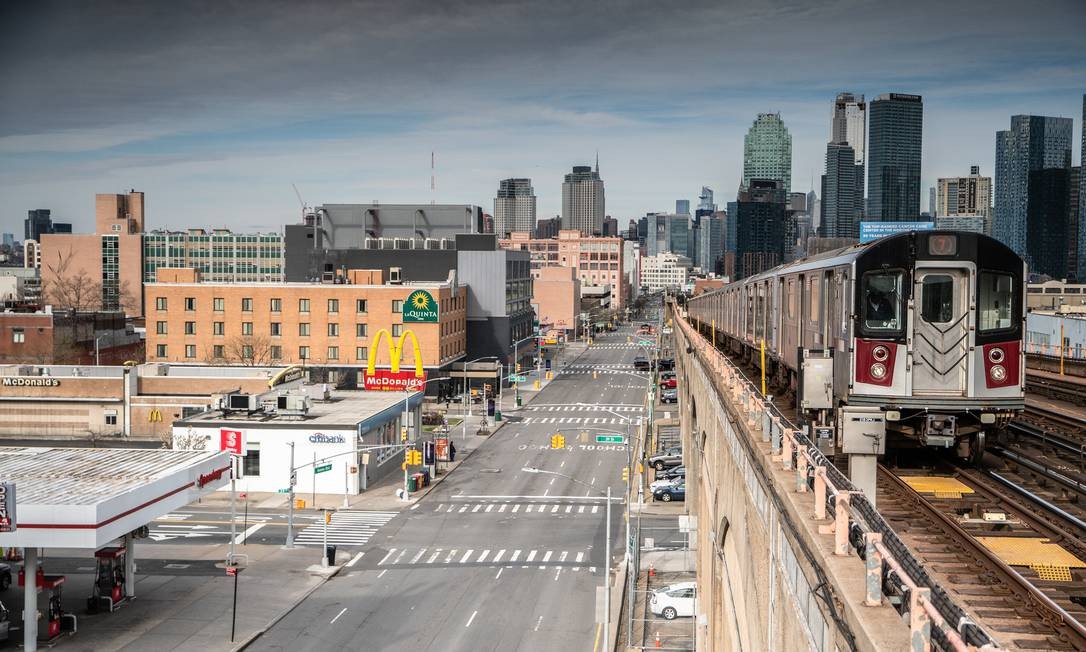 Deserted streets in New York City's Queens district contrast with subway operation: Governor Andrew Cuomo and Mayor Bill de Blasio are under pressure to take even more drastic action Photo: JUAN ARREDONDO / NYT