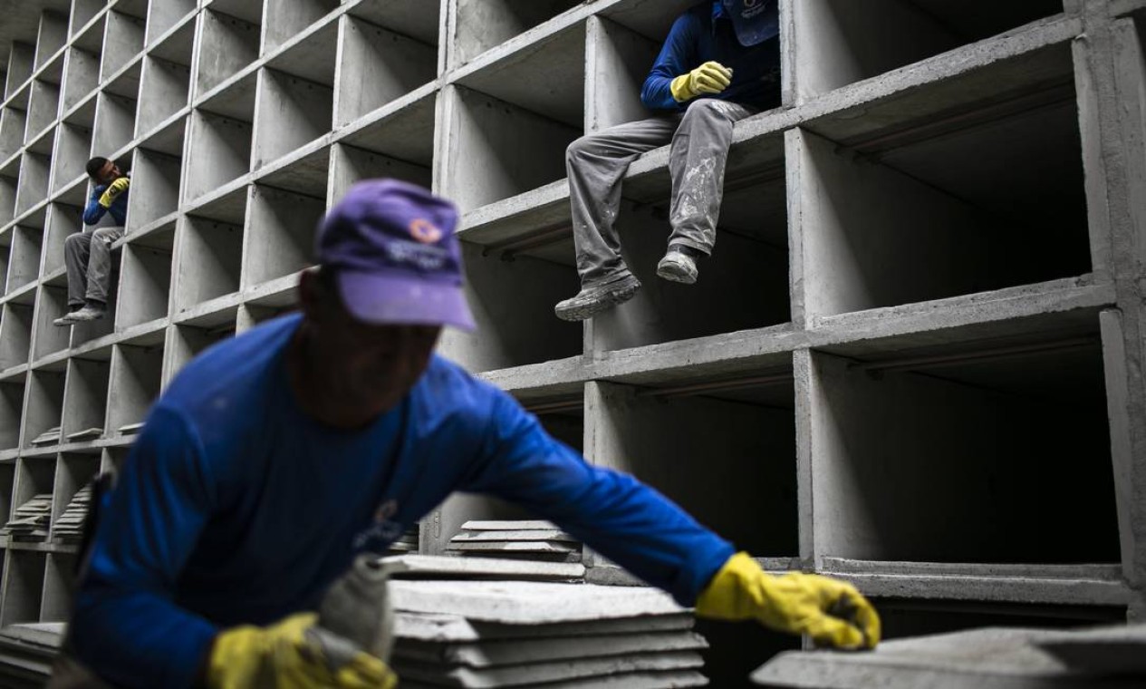 Funcionários trabalham na construção de novas gavetas, no Cemitério do Caju, destinadas a vítimas da Covid-19 Foto: Hermes de Paula / Agência O Globo