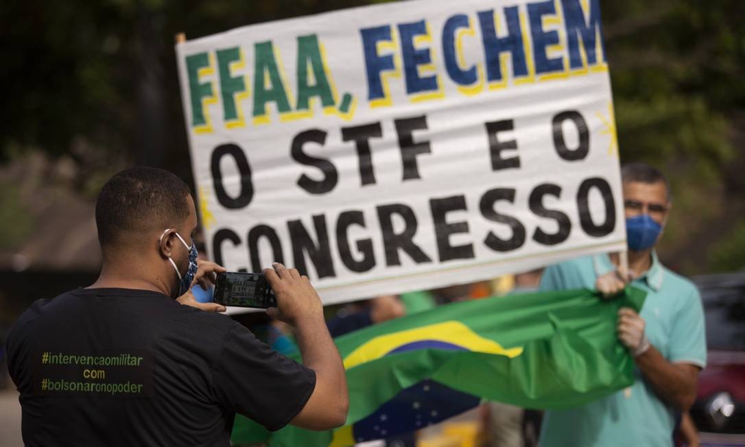 Menifestantes seguram cartaz que pede fechamento do Congresso e do STF Foto: Gabriel Monteiro / Agência O Globo