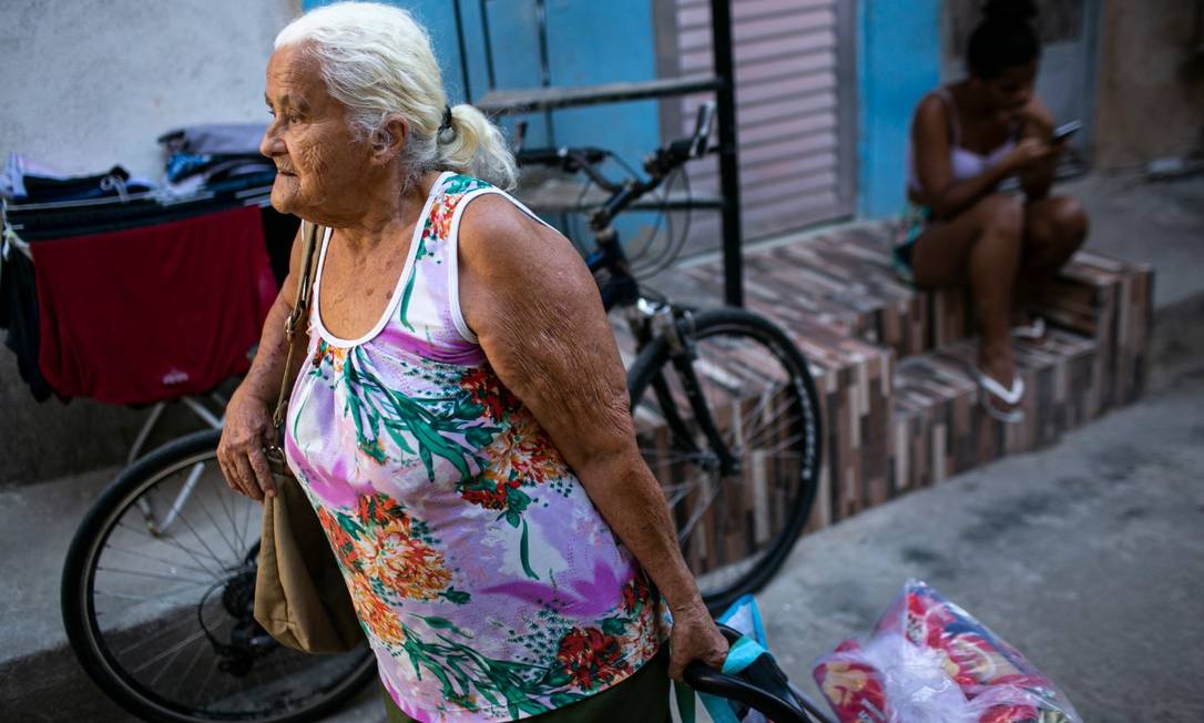 Maria das Dores Costa, 80 anos. Com dificuldades, a senhora foi sozinha buscar a cesta e foi ajudada pelos moradores Foto: Hermes de Paula / Agência O Globo