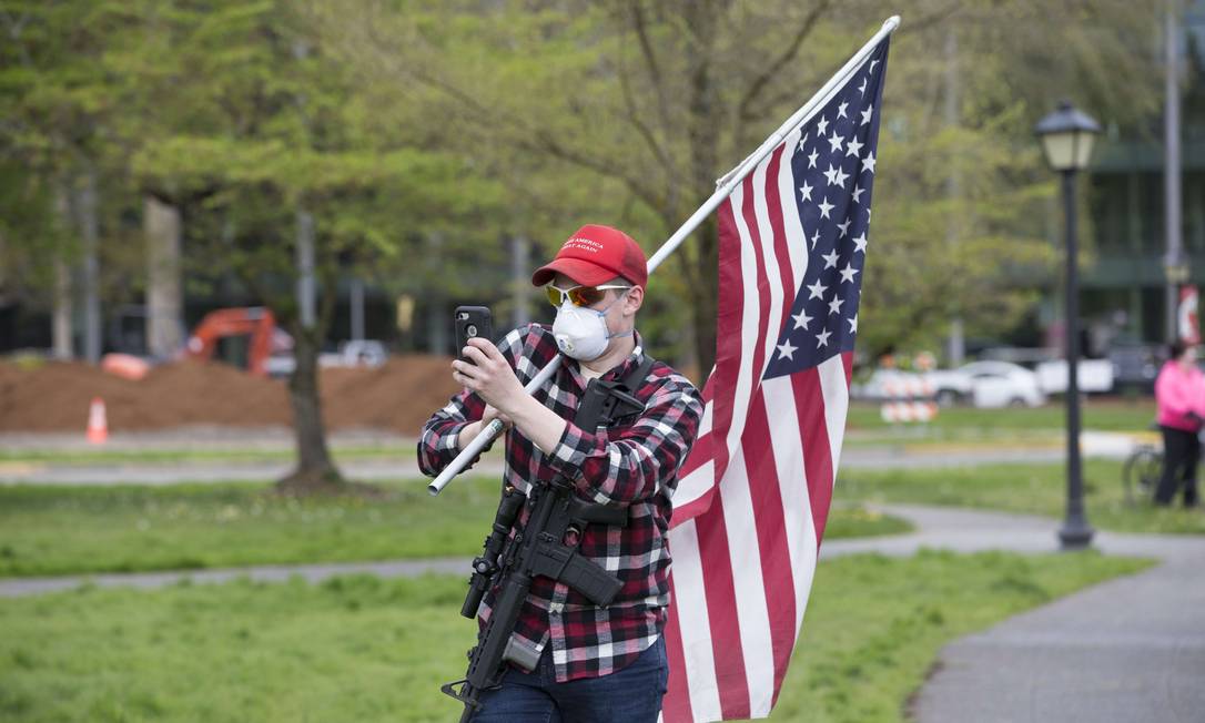 Homem armado protesta contra ordem de quarentena em Washington, capital dos EUA Foto: Karen Ducey / AFP