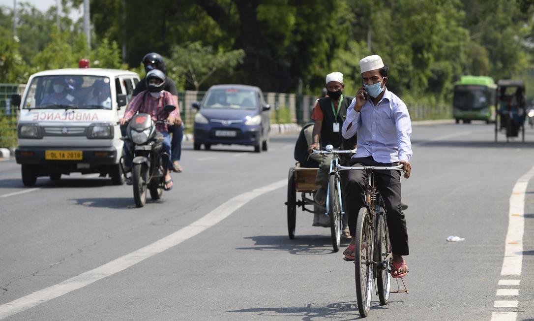 Homem pedala em estrada em Nova Délhi: milhares de trabalhadores voltaram para suas aldeias após lockdown na Índia Foto: SAJJAD HUSSAIN / AFP