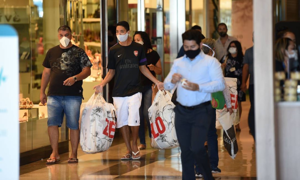 As pessoas usam máscara em um shopping em Brasília, no primeiro dia de reabertura de negócios na cidade em meio à pandemia de coronavírus Foto: EVARISTO SA / AFP