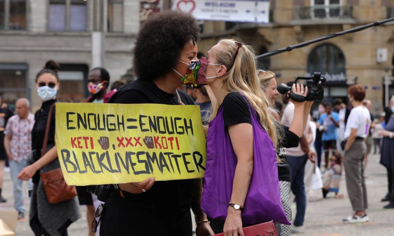 Mulher negra beija uma mulher branca em protesto em Amsterdã, na Holanda Foto: EVA PLEVIER / REUTERS - 01/06/2020