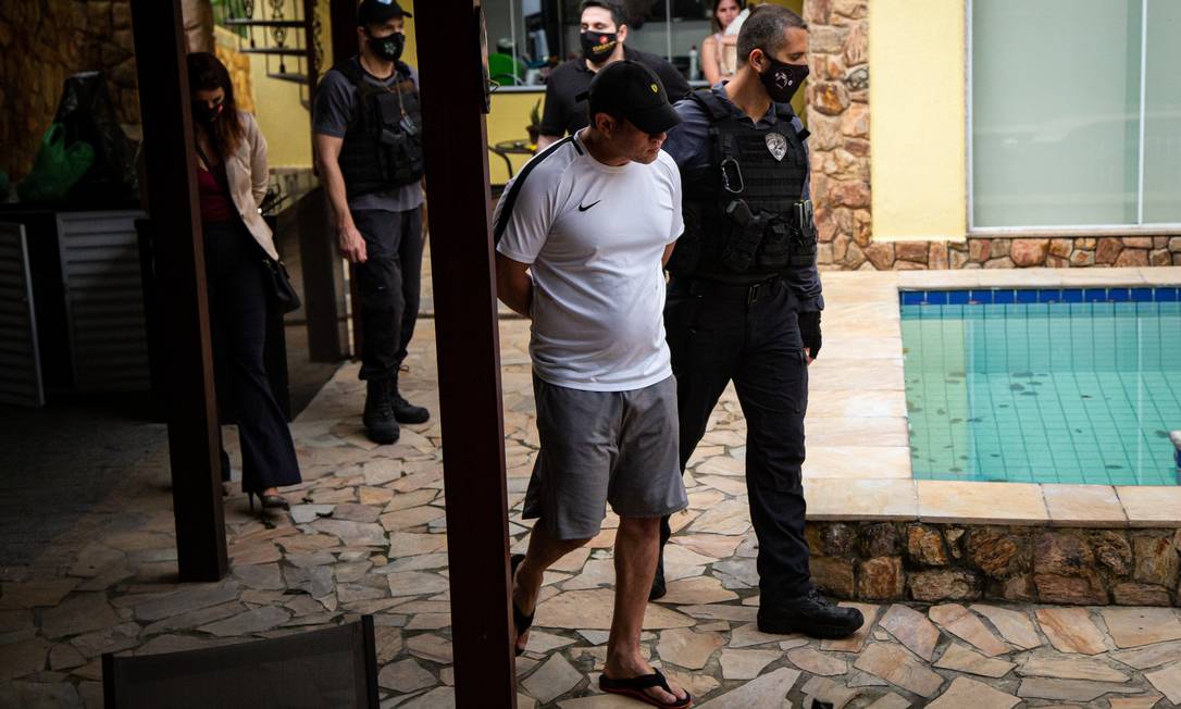 Leonardo Gouvea da Silva , o Mad, é conduzido por um agente logo após ser preso Foto: Hermes de Paula / Agência O Globo