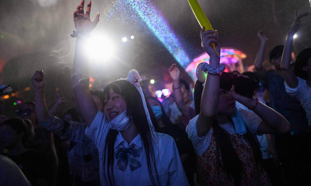 Pessoas em festival de música em Wuhan, na China, abaixaram ou nem levaram máscaras Foto: Hector Retamal / AFP
