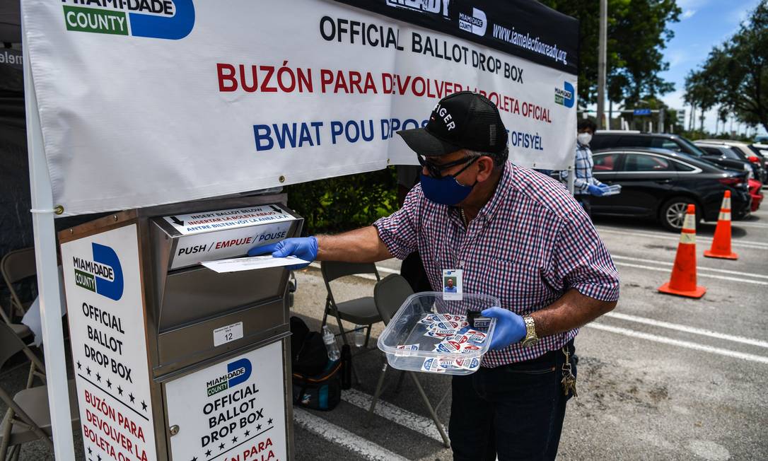 Eleitor deposita voto postal em primárias na Flórida; a maioria dos estados americanos já permitia esse tipo de voto, mas ele será mais usado neste ano Foto: CHANDAN KHANNA / AFP