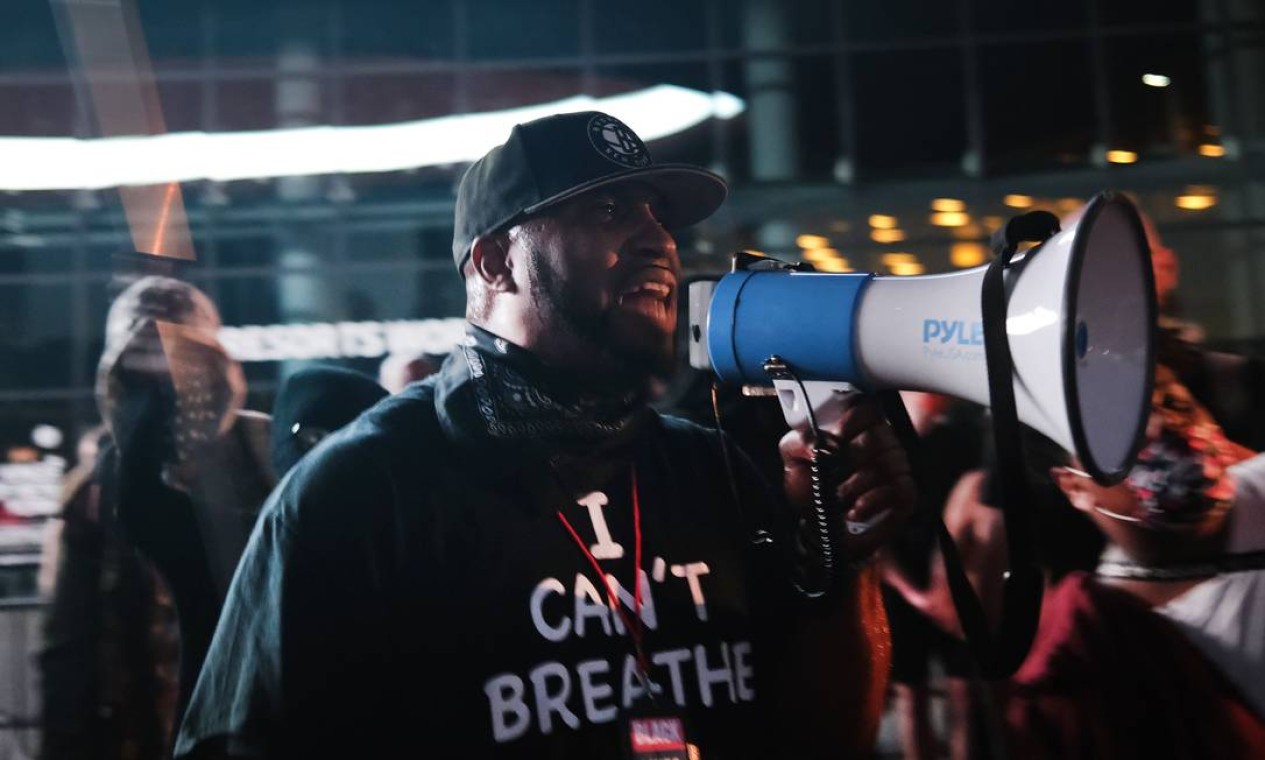 Membro do Black Lives Matters (BLM) discursa vestindo camisa que trás a frase icônica dita pro George Floyd enquanto era sufocado até a morte por policiais: "eu não consigo respirar" Foto: SPENCER PLATT / AFP
