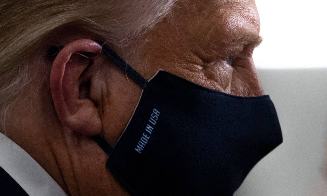 Trump, in an Aug. 6 photo, wears a mask that says 