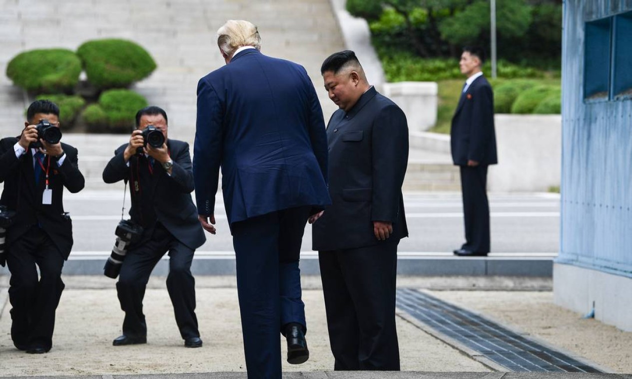 O presidente dos Estados Unidos, Donald Trump, caminha para o lado norte da Linha de Demarcação Militar que divide as Coreias do Norte e do Sul, sob o olhar do líder norte-coreano Kim Jong-un, em Panmunjom Foto: BRENDAN SMIALOWSKI / AFP - 30/06/2019