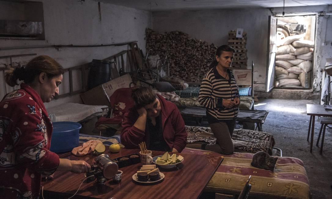Moradores preparam comida enquanto se abrigam no porão de um prédio de apartamentos em Stepanakert, em Nagorno-Karabakh Foto: SERGEY PONOMAREV / NYT/14-10-2020