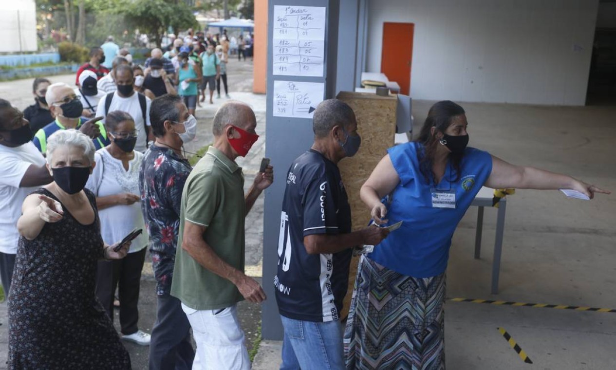 Pessoas que trabalham nas seções tentam organizar fluxo de entrada de eleitores para evitar aglomerações Foto: Fabiano Rocha / Agência O Globo