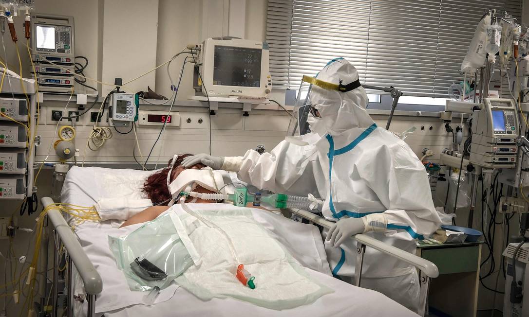 Enfermeira cuida de paciente na UTI, na Grécia Foto: LOUISA GOULIAMAKI/AFP / LOUISA GOULIAMAKI/AFP