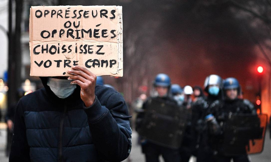 A protester holds a sign that says 