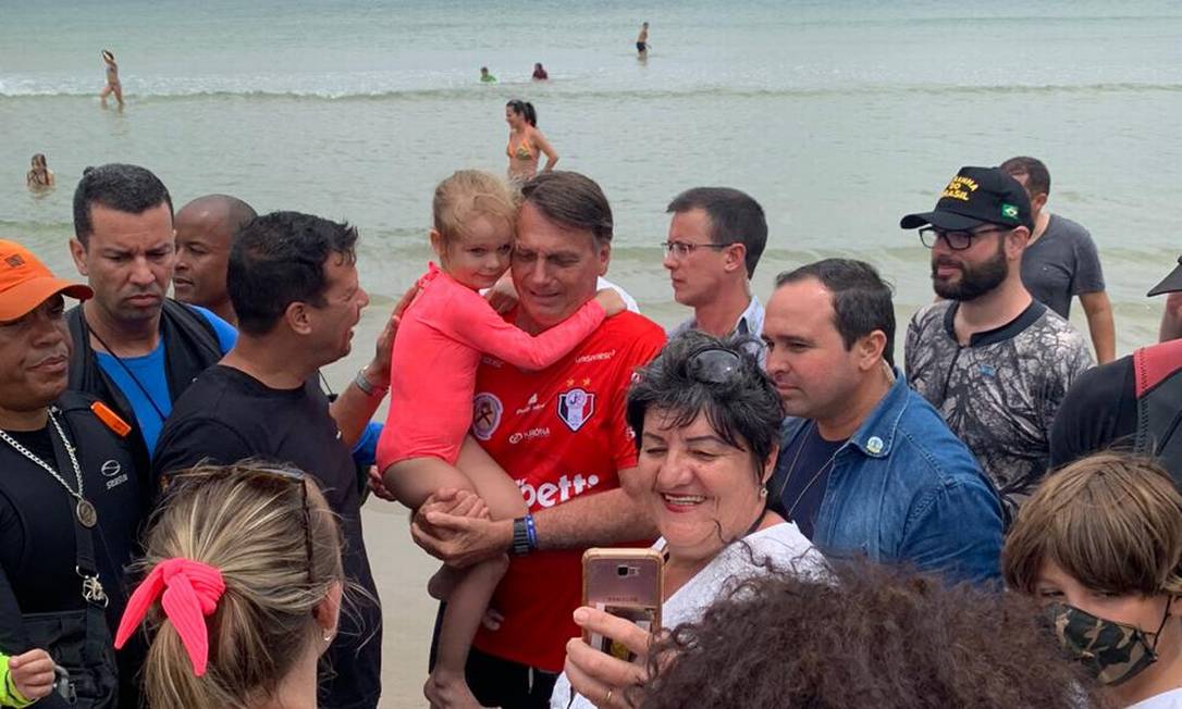 Bolsonaro cumprimentou apoiadores, tirou fotos com alguns deles e pegou crianças no colo na praia Foto: Julia Lindner/ O Globo
