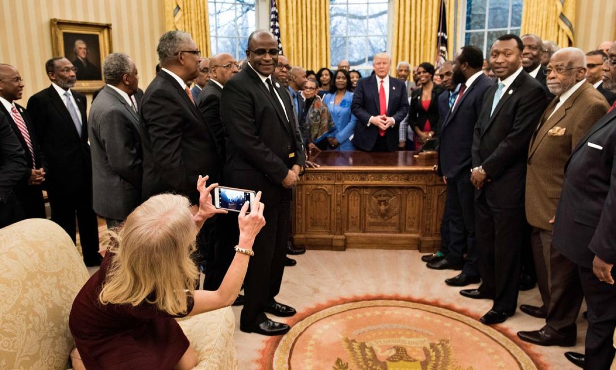Kellyanne Conway, conselheira do presidente Donald Trump, tira uma foto enquanto o ele e líderes de universidades e faculdades historicamente negras conversam no Salão Oval da Casa Branca, em fevereiro de 2017 Foto: BRENDAN SMIALOWSKI / AFP - 27/02/2017