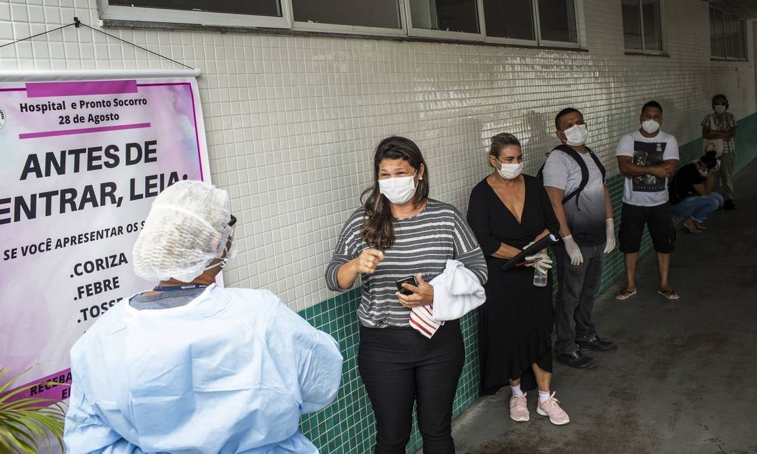 Pessoas com sintomas da Covid-19 aguardam em fila para atendimento no Hospital e Pronto Socorro 28 de Agosto, em Manaus Foto: Raphael Alves / Agência O Globo
