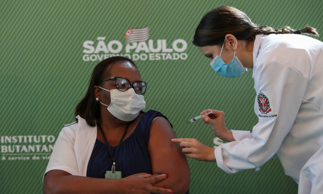 A enfermeira Mônica Calazans, 54 anos, recebe a primeira dose da vacina contra o novo coronavírus logo após a Anvisa aprovar seu uso de emergêncial, no Hospital das Clínicas de São Paulo. Mônica se tornou a primeira pessoa em território brasileiro a ser vacinada contra a Covid-19 Foto: AMANDA PEROBELLI / REUTERS - 17/01/2021